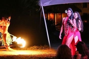 a woman standing in front of a fire