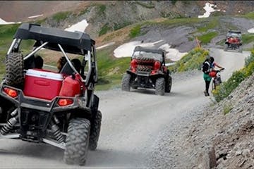 ATVs going on a tour on a dirt road.