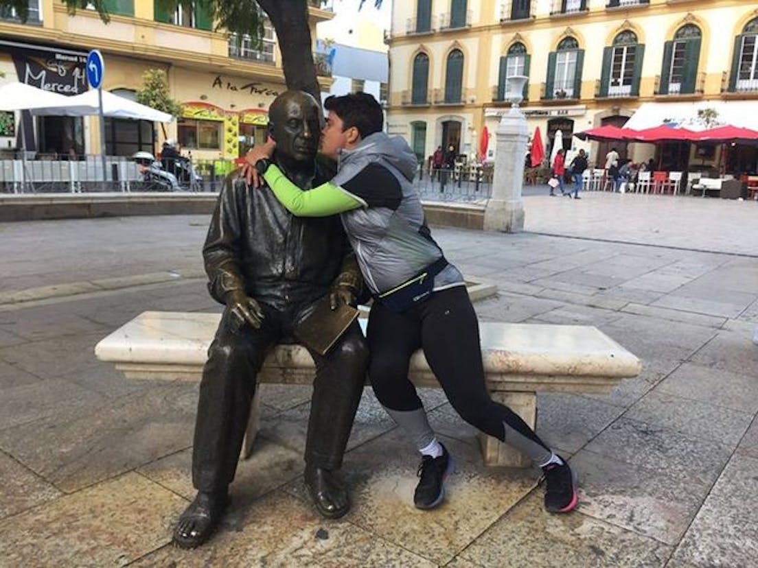 Man kissing statue