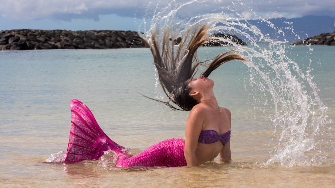 A mermaid flipping her hair in Honolulu, HI