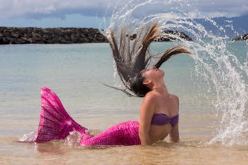 A mermaid flipping her hair in Honolulu, HI