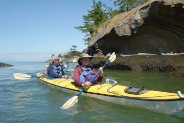 kayakers near a rocky shore