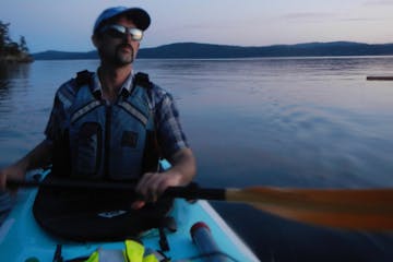 Man on full moon tour in kayak