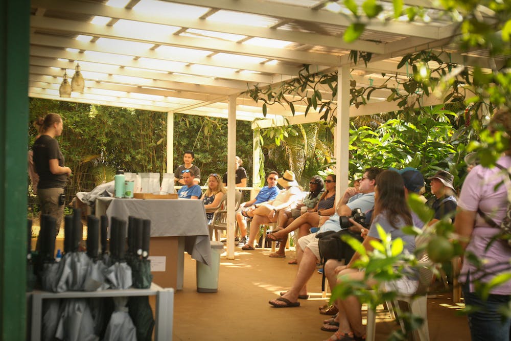 lydgate tour guests sit under the covered lanai for a chocolate tasting