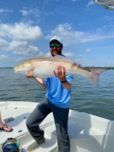 Capt. Tyler holding a large Bull Red