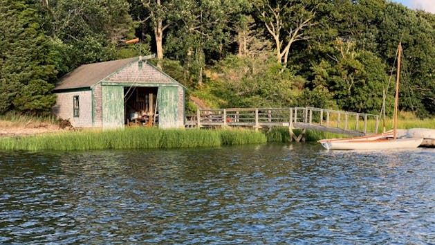 a small house surrounded by water