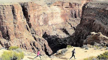 a group of people in a canyon
