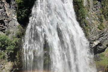 a large waterfall over some water