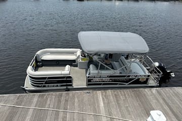 a boat that is sitting on a dock next to a body of water