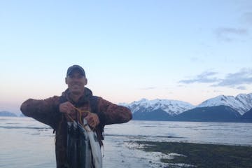 Holding up an awesome catch along a shore fishing trip in Seward Alaska