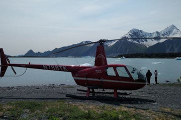 a helicopter landed on a beach in Seward, Alaska