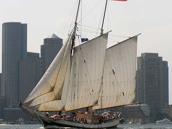 Liberty Clipper flying the American flag in the Boston Harbor