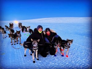 a group of people riding skis on top of a dog