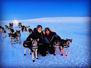 a group of people riding skis on top of a dog
