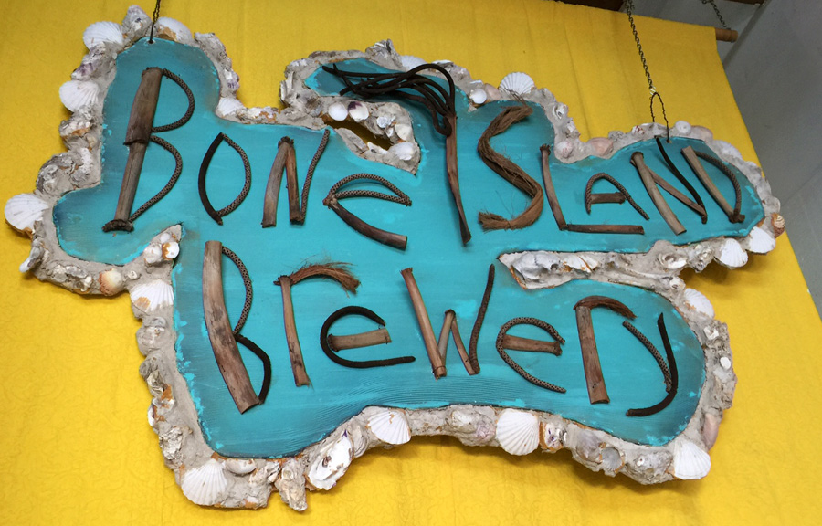 hand crafted Bone Island logo sign made with beach wood and shells 