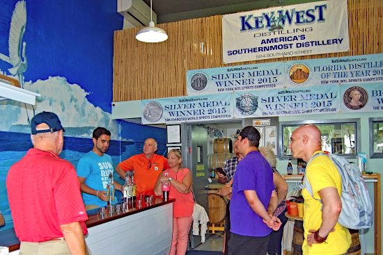 Key West Food Tour guide pours spirit tastings for tour guests at Key West Distilling 