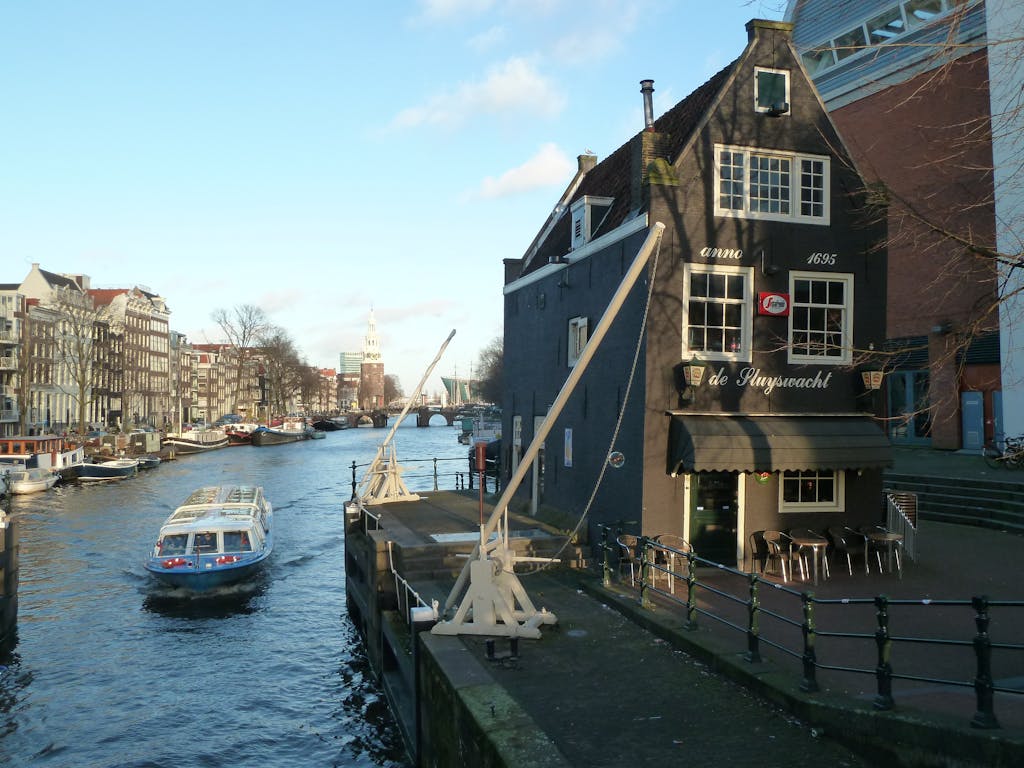 view of Cafe Sluyswacht next to a canal romantic cafe to visit in Amsterdam
