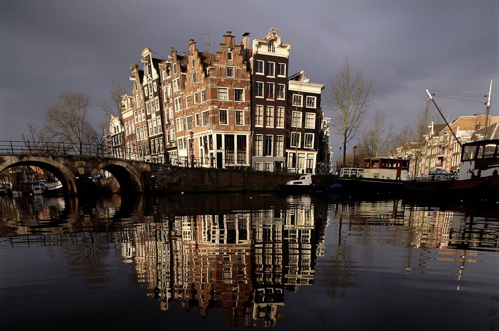 Historic houses on canal corner in Amsterdam