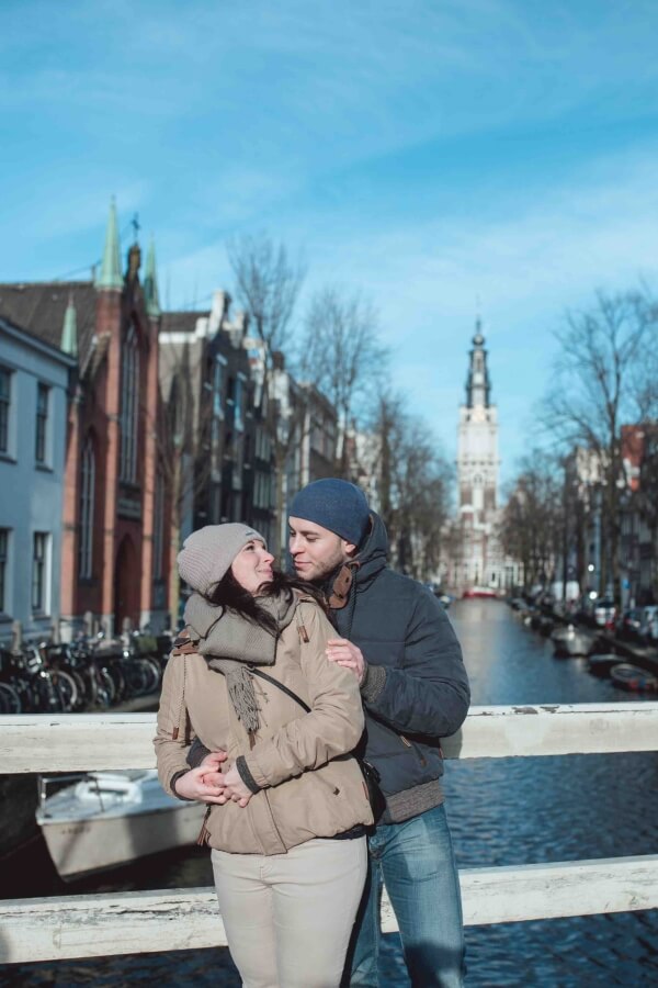 Amsterdam love lock bridge with a couple kissing