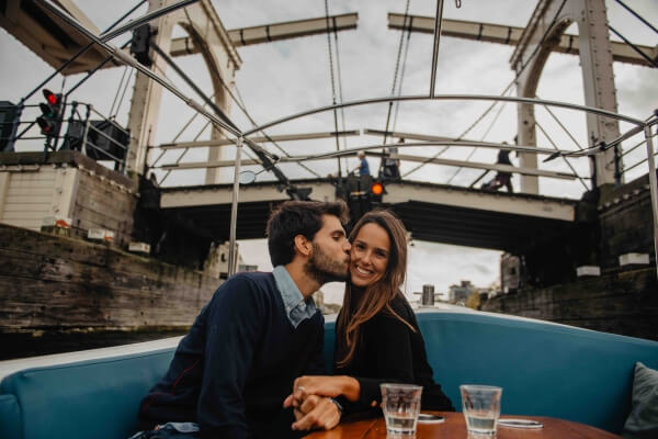 Amsterdam Proposal kissing under skinny bridge in