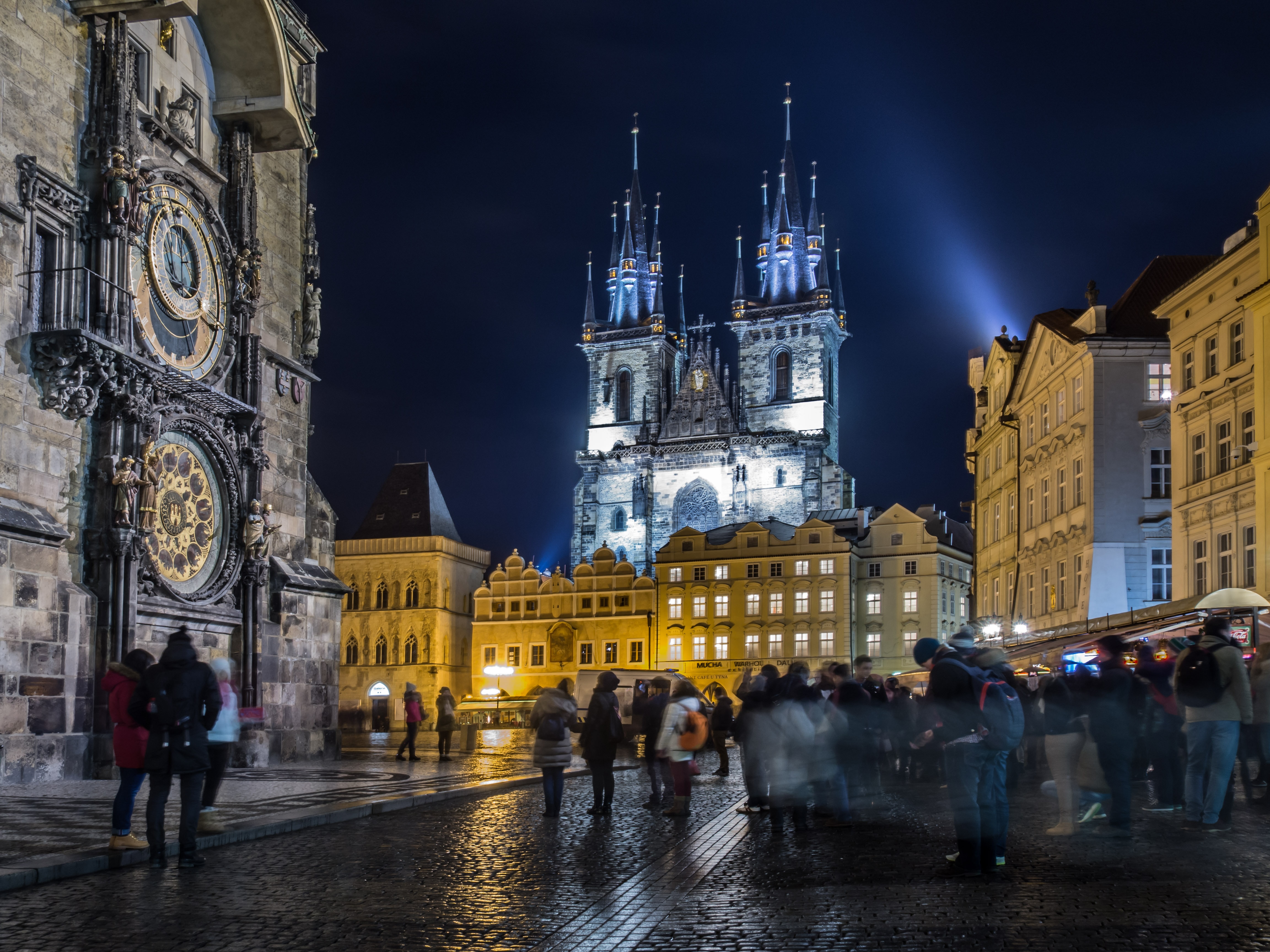 the Old Town Square at night with the Astronomical clock on the left and the Tyn Church in the Background