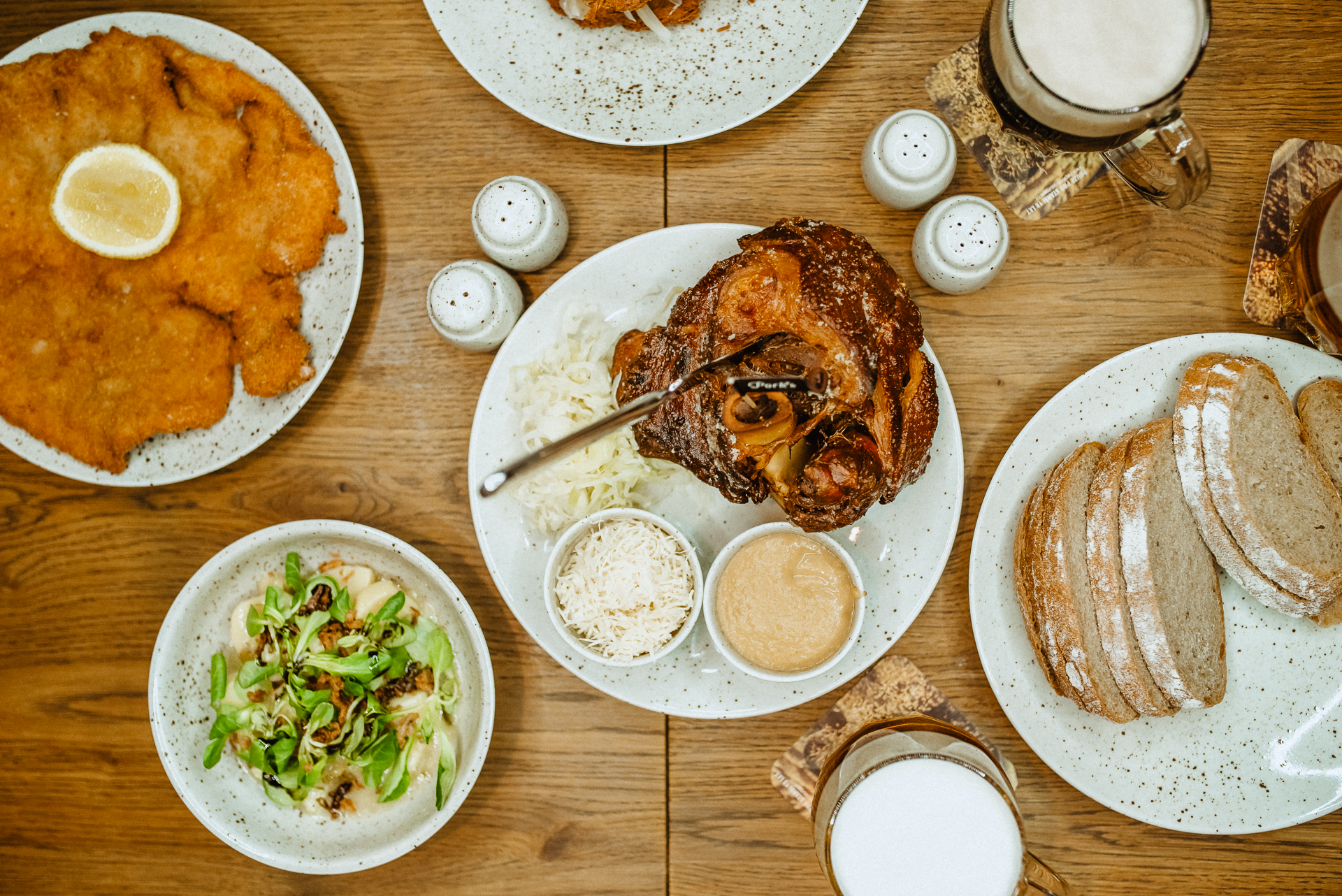 a wooden table topped with plates of food on a plate