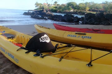 Kayak rentals sitting on a beach