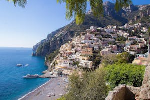 a large body of water with Amalfi Coast in the background