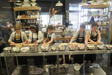 a group of people performing on a counter in a store