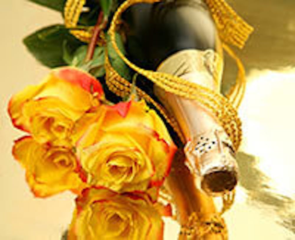 Champagne and yellow roses on gold reflective surface