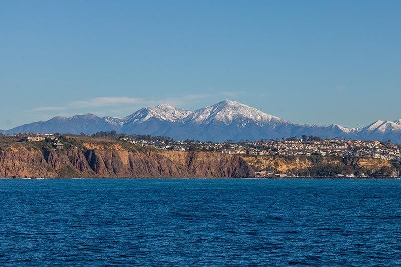 View of Dana Point coastline with scenic mountains in the background