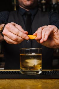 a man holding a glass of orange juice