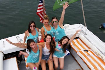 a group of people on a boat posing for the camera