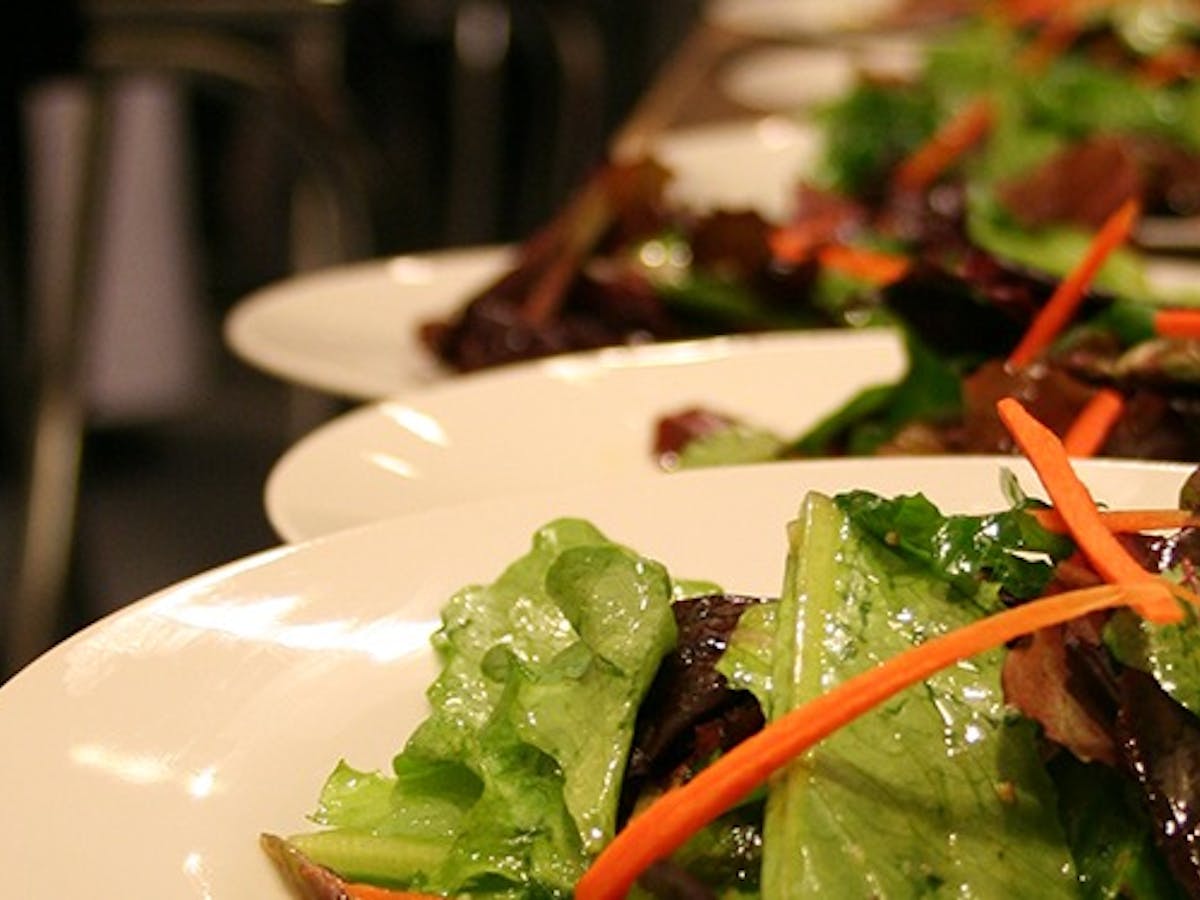 Fresh salads on white plates