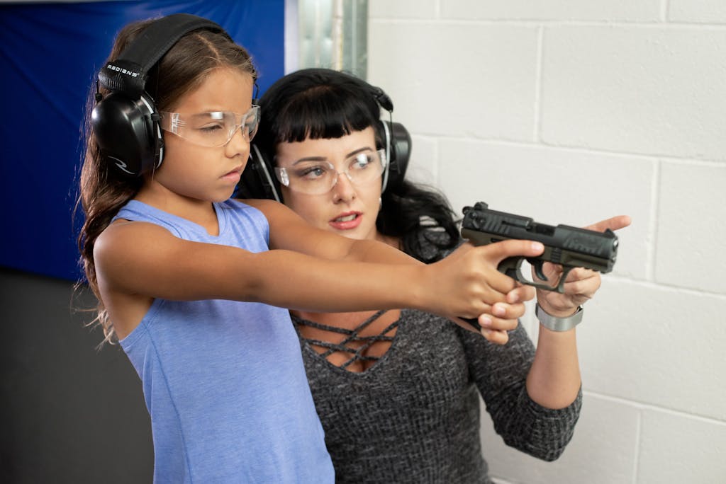 Kris Chanski shows little girl how to shoot a gun