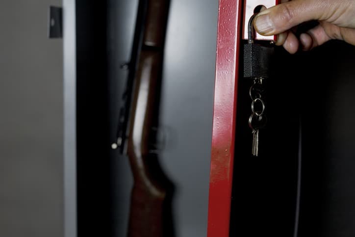 Gun safe with rifle inside and lock on the door