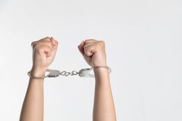 handcuffs around someone's arms