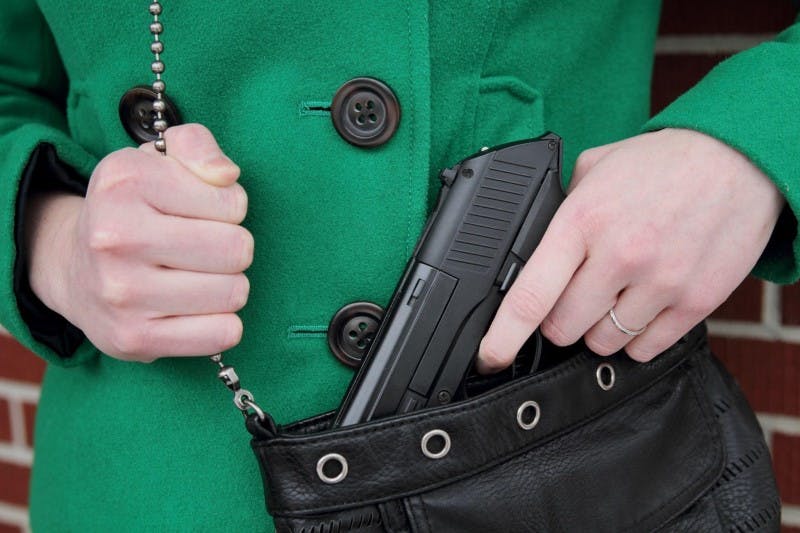woman with concealed carry pistol in purse