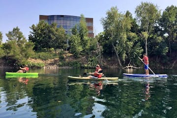 a group of people paddling a kayak in the water