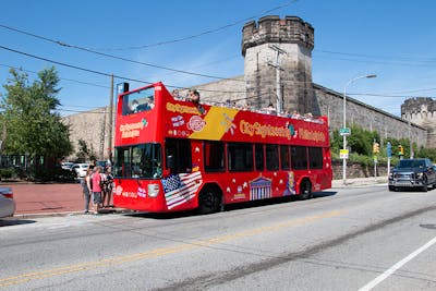 a red double decker bus parked on the side of a road