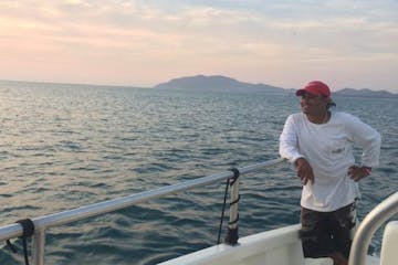 Man on catamaran looking across water