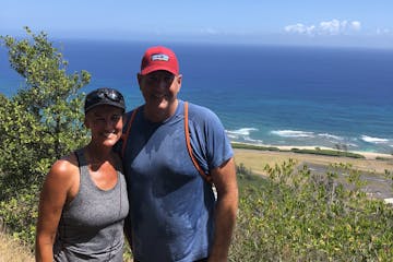 man and woman smiling on hike in oahu