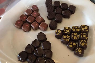 a white plate topped with different types of chocolate on a table