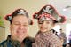 A father and son wearing pirate hats