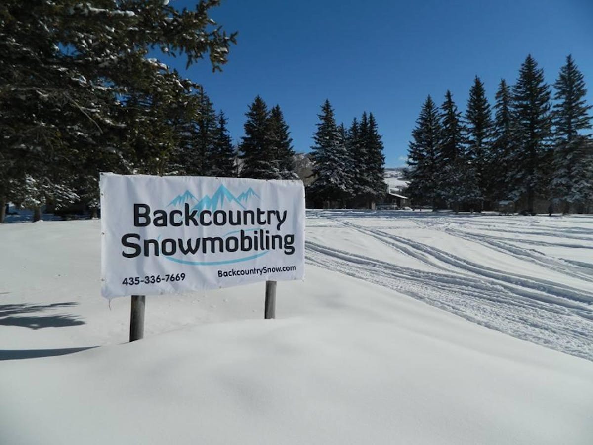 Backcountry Snowmobiling sign in the snow