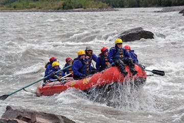 Friends rafting among rapids