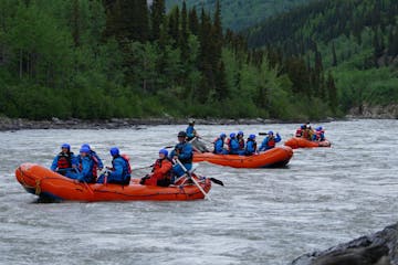 a group of people on a raft in a body of water