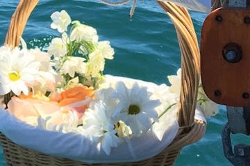 Roses to be thrown into ocean for a burial at sea funeral service.