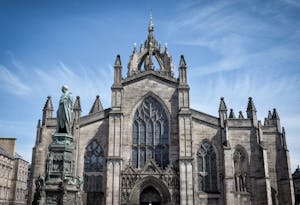 a church with a clock on the front of St Giles' Cathedral