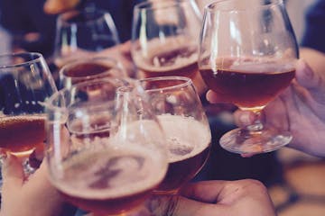 A close up picture of a group toasting